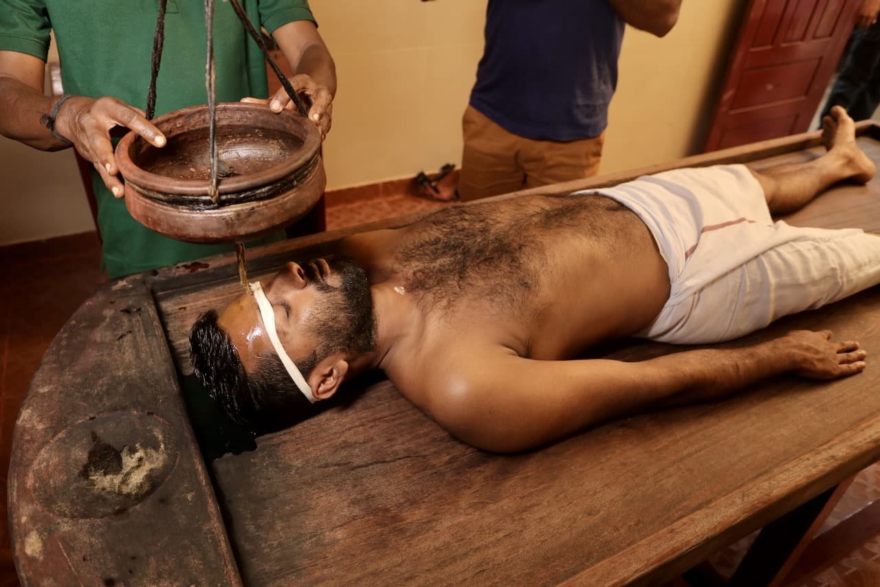 Traditional panchakarma therapy facility with authentic Ayurvedic equipment