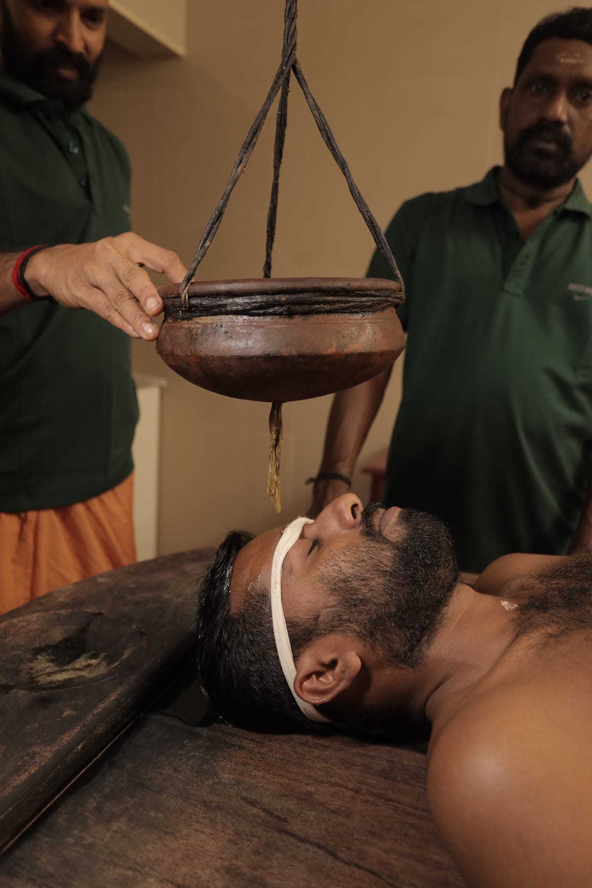 Shirodhara therapy - warm oil poured on forehead for stress relief and mental clarity